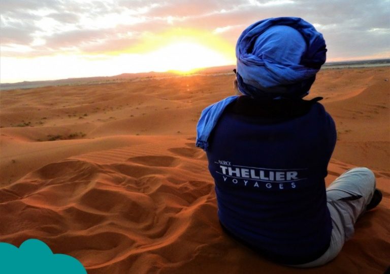 Solo traveler watching sunrise over Erg Chebbi dunes – Solo Travel Morocco