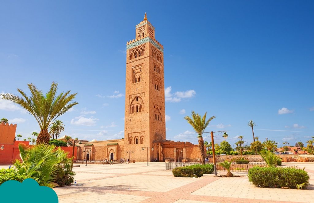 Solo traveler viewing Koutoubia Mosque from a Marrakech terrace – Solo Travel Morocco