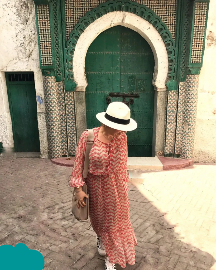 Traveler wearing Morocco travel outfits walking through Marrakech Medina