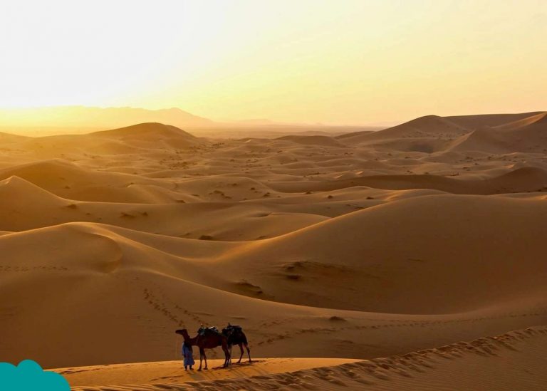 Sunrise over Merzouga dunes as seen from a Morocco Camel Trek in Merzouga.