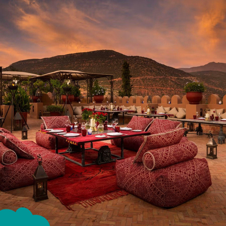 Couple enjoying Morocco honeymoon packages with a camel ride at sunset in the Sahara Desert