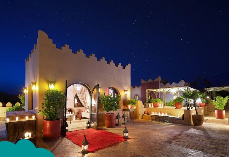 Couple enjoying Morocco honeymoon packages at Kasbah Tamadout with stunning mountain views