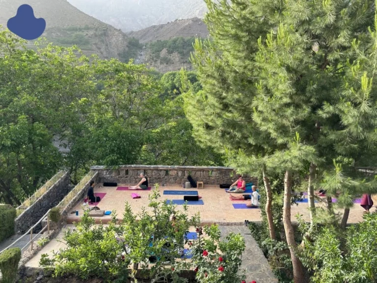 Meditation near a waterfall at a yoga retreat in Morocco Atlas Mountains
